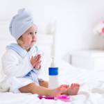 Девочка в тёплом халатике и в полотенце на голове после ванны