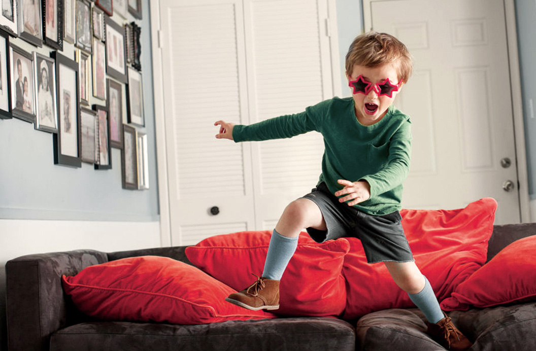 Мальчик скачет по дивану