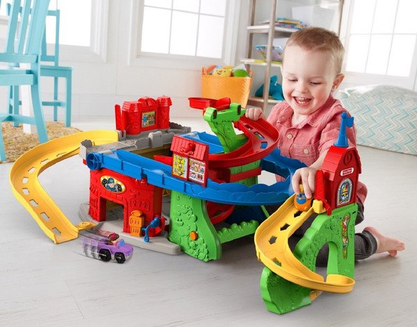 Мальчик запускает машинки по треку